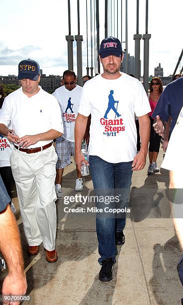 Actor Gerard Butler walks across the George Washington Bridge as he participates in the "Giant Steps For 9/11" walk on September 13, 2009 in New York...