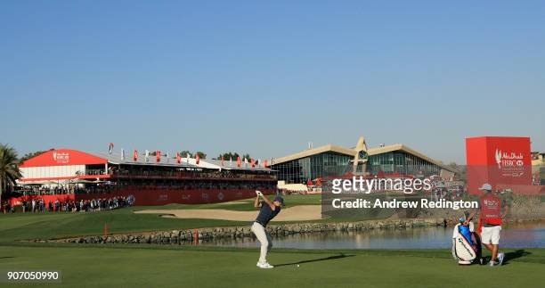 Rory McIlroy of Northern Ireland plays his second shot on the 18th hole during round two of the Abu Dhabi HSBC Golf Championship at Abu Dhabi Golf...