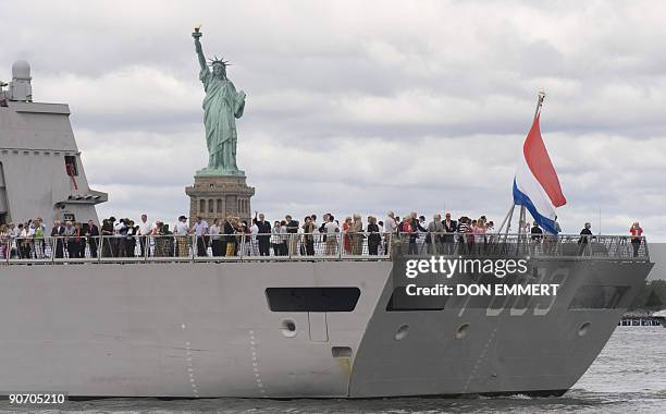 Passengers stand aboard the Dutch Naval Frigate HNMLS Tromp as it sails past the Statue of Liberty on September 13, 2009 in New York Harbor. The ship...