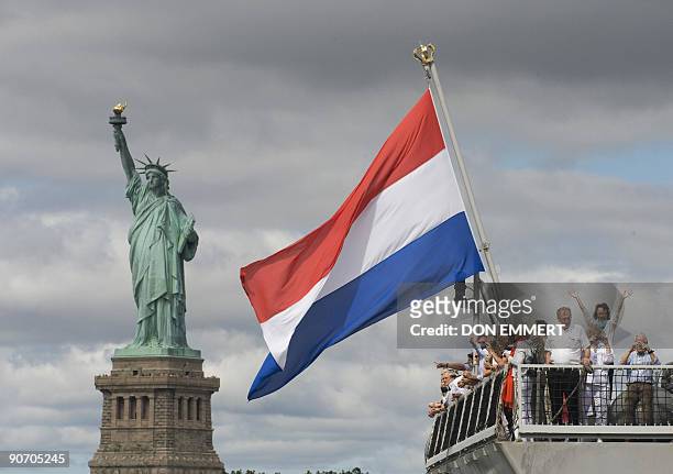 Passengers stand aboard the Dutch Naval Frigate HNMLS Tromp as it sails past the Statue of Liberty on September 13, 2009 in New York Harbor. The ship...