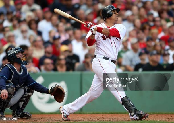 Victor Martinez of the Boston Red Sox gets a hit as Gregg Zaun of the Tampa Bay Rays defends on September 8, 2009 at Fenway Park in Boston,...