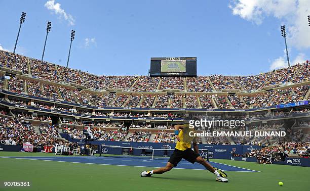 Tennis player Rafael Nadal from Spain stretches to reach a ball against Juan Martin Del Potro from Argentina during their semifinals match of the...
