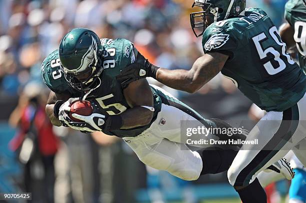 Defensive end Victor Abiamiri of the Philadelphia Eagles recovers a Jake Delhomme fumble and dives into the end-zone for a touchdown during the game...