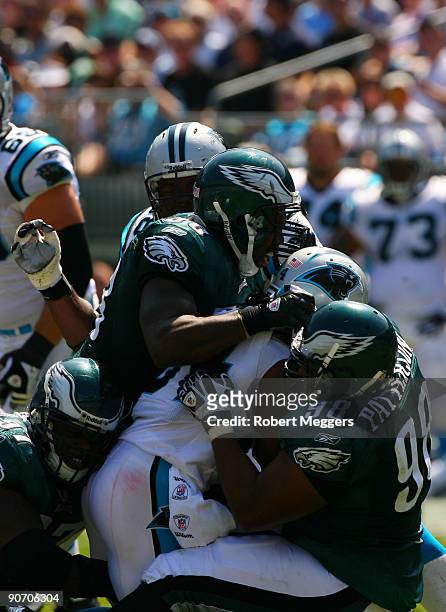 DeAngelo Williams of the Carolina Panthers is stopped by linebacker Omar Gaither and tackle Mike Patterson of the Philadelphia Eagles during their...
