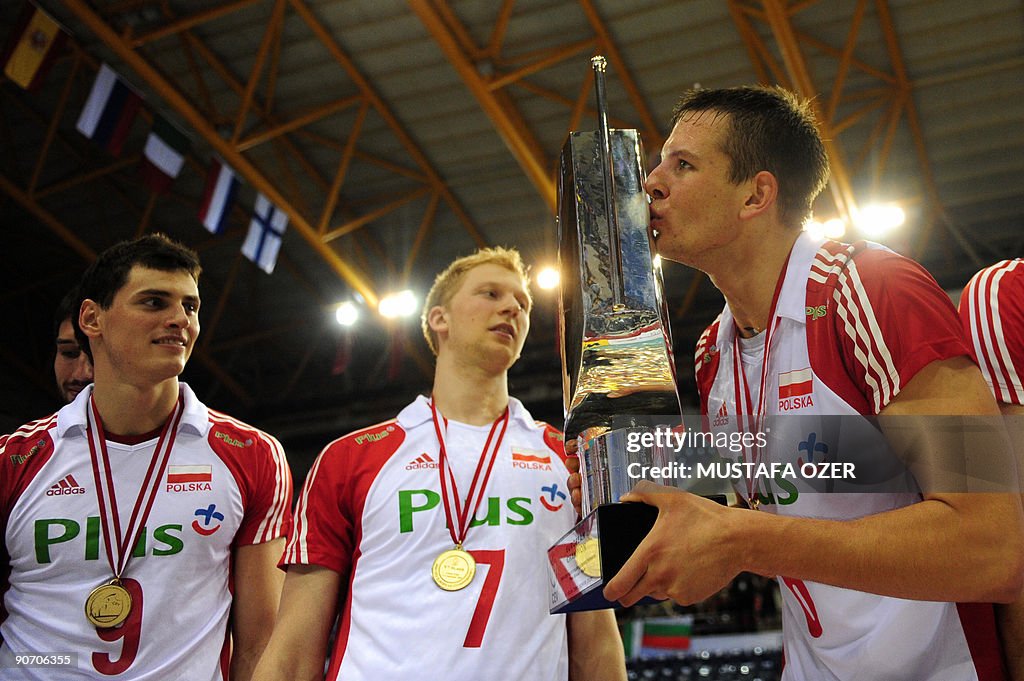 Bartosz Kurek (R) kisses the trophy as t