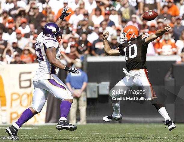 Brady Quinn of the Cleveland Browns fumbles the ball as he is pressured by Kevin Williams of the Minnesota Vikings at Cleveland Browns Stadium on...