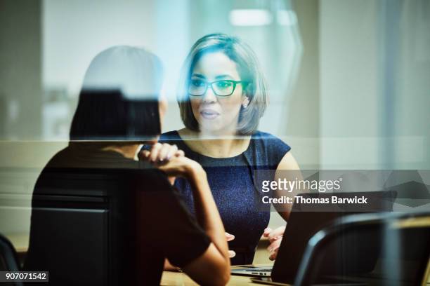businesswoman in discussion with client in office conference room - financial assistance stock pictures, royalty-free photos & images