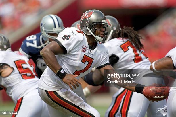Quarterback Byron Leftwich of the Tampa Bay Buccaneers hands the ball off against the Dallas Cowboys during the game at Raymond James Stadium on...