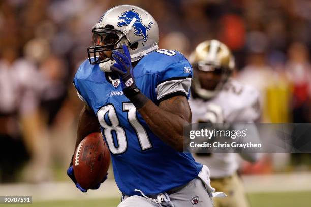 Calvin Johnson of the Detroit Lions runs past Malcom Jenkins of the New Orleans Saints at the Louisiana Superdome on September 13, 2009 in New...