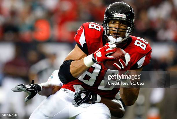 Tony Gonzalez of the Atlanta Falcons pulls in this reception against Gibril Wilson of the Miami Dolphins at Georgia Dome on September 13, 2009 in...