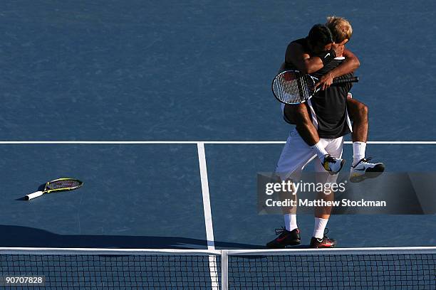 Leander Paes of India and Lukas Dlouhy of the Czech Republic celebrate championship point after defeating Mahesh Bhupathi of India and Mark Knowles...