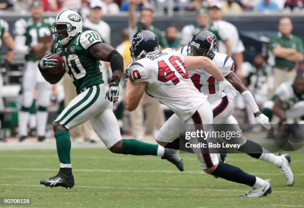 Running back Thomas Jones of the New York Jets eludes free safety John Busing of the Houston Texans as he scores on a 38 yard run in the fourth...