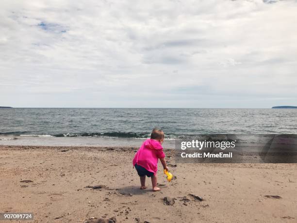 toddler playing on a sandy beach - perce rock stock pictures, royalty-free photos & images