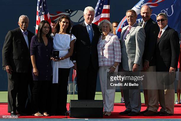 Camera Ashe, Jeanne Marie Moutoussamy, former President Bill Clinton and USTA president Lucy S. Garvin at the ceremony to induct Ashe into the U.S....