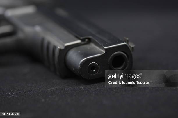 a black pistol  (gun) - shooting a weapon stock pictures, royalty-free photos & images