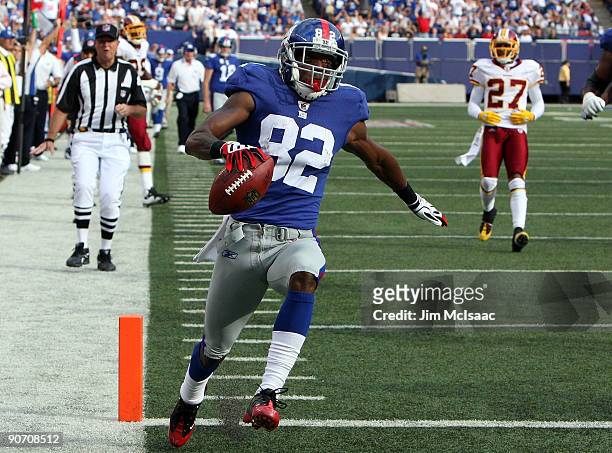 Mario Manningham of the New York Giants runs in a second quarter touchdown against the Washington Redskins on September 13, 2009 at Giants Stadium in...
