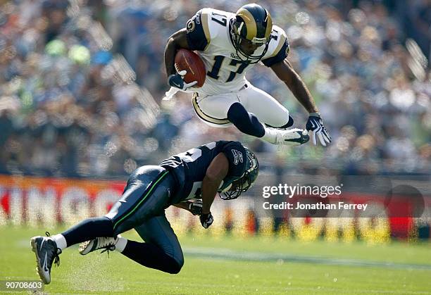 Donnie Avery of the St. Louis Rams leaps over Josh Wilson of the Seattle Seahawks at Qwest Field on September 13, 2009 in Seattle, Washington.