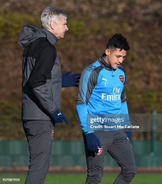 Arsenal manager Arsene Wenger talks to Alexis Sanchez before a training session at London Colney on January 19, 2018 in St Albans, England.