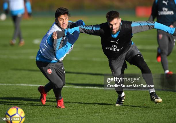 Alexis Sanchez and Mathieu Debuchy of Arsenal during a training session at London Colney on January 19, 2018 in St Albans, England.