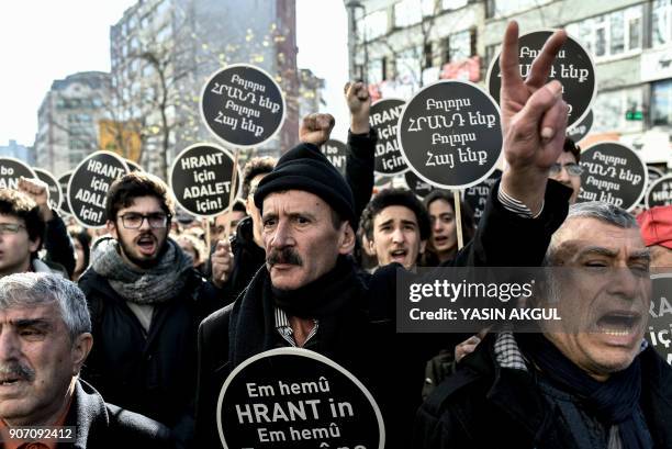 People shout slogans as they hold placards reading "We all are Hrant, we all are Armenians" in front of the offices of Armenian weekly newspaper...