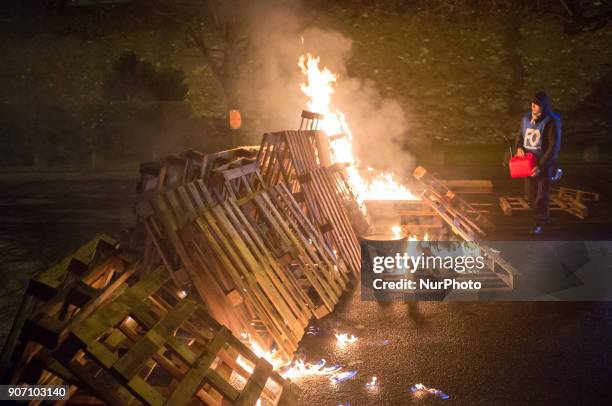 Wooden palettes burn as prison guards block access to Fresnes prison on January 19, 2018 to demand tighter security. French prison officers blocked...