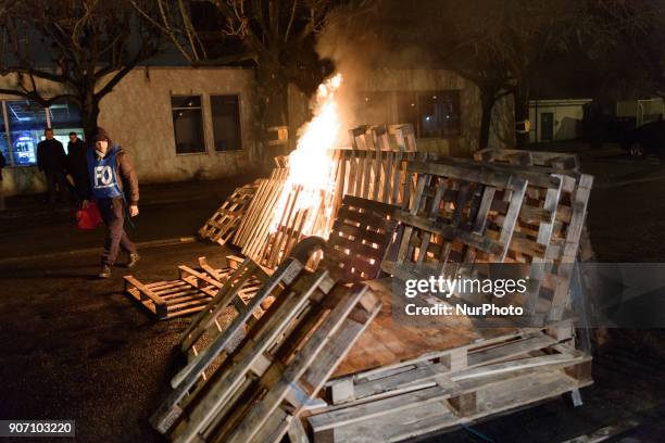 Wooden palettes burn as prison guards block access to Fresnes prison on January 19, 2018 to demand tighter security. French prison officers blocked...