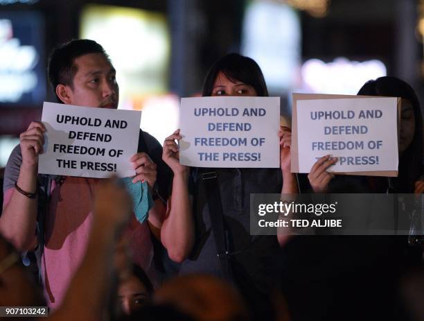 Journalists and supporters display placards during a protest in favour of the freedom of press in Manila on January 19, 2018. Philippine journalists...