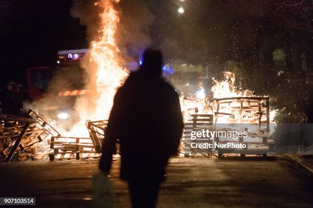 Wooden palettes burn as prison guards block access to Fresnes prison on January 19, 2018 to demand tighter security. French prison officers blocked...