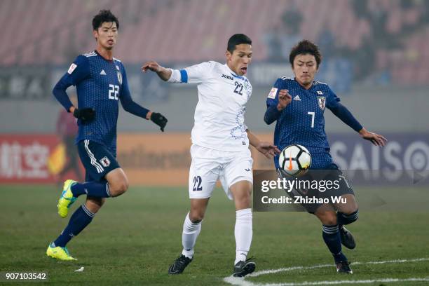 Hara Teruki of Japan and Abdixolikov Bobir of Uzbekistan in action during AFC U23 Championship Quarter-final between Japan and Uzbekistan at Jiangyin...