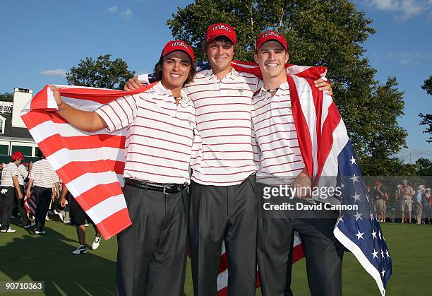 Rickie Fowler, Peter Uihlein and Morgan Hoffman of the USA celebrate on the 18th green after the USA had secured victory, during the final afternoon...