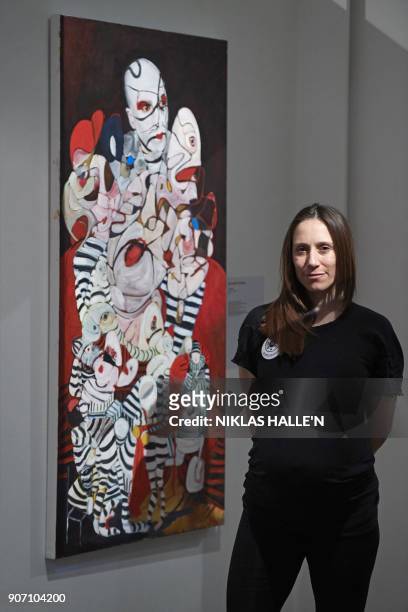 British artist Dannielle Hodson poses for a photograph next to her painting titled, The Flasher, at Sotheby's auction house in central London on...