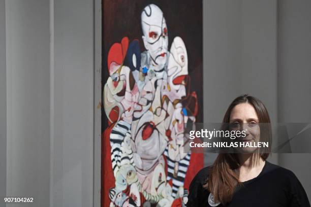 British artist Dannielle Hodson poses for a photograph next to her painting titled, The Flasher, at Sotheby's auction house in central London on...