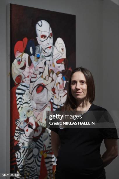 British artist Dannielle Hodson poses for a photograph next to her painting titled, The Flasher, at Sotheby's auction house in central London on...