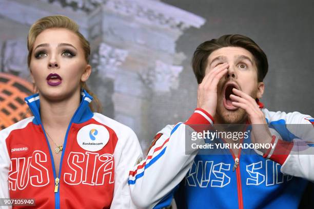Russia's Alexandra Stepanova and Ivan Bukin wait for the result after performing during their ice dance short dance at the ISU European Figure...