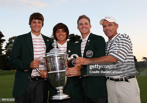Peter Uihlein, Rickie Fowler, Morgan Hoffman of the USA with the trophy after the USA had won the match, all are members of the Oklahoma State...