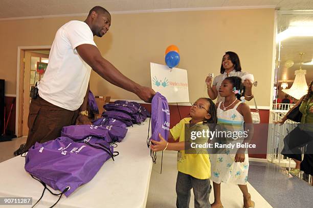 Dwyane Wade of the Miami Heat distributes backpacks with school supplies on September 13, 2009 at Temple of Praise Binding and Loosing Ministries...