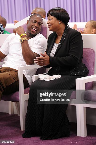 Dwyane Wade of the Miami Heat shares a moment with his mother Pastor Jolinda Wade after addressing the congregation of Temple of Praise Binding and...