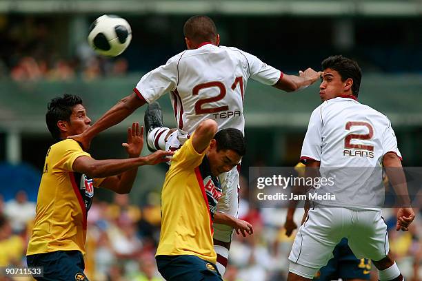 Juan Carlos Valenzuela and Oscar Rojas of Aguilas del America vies for the ball with Diego Jimenez and Oswaldo Alanis of Estudiantes Tecos during...