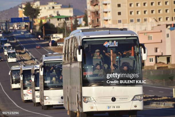 Military convoy carries Syrian opposition rebels backed by Ankara in Hassa, Hatay Province, near the Turkish-Syrian border on January 19, 2018. / AFP...