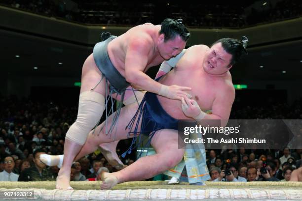 Mongolian wrestler Arawashi throws Ikioi to win during day six of the Grand Sumo New Year Tournament at Ryogoku Kokugikan on January 19, 2018 in...