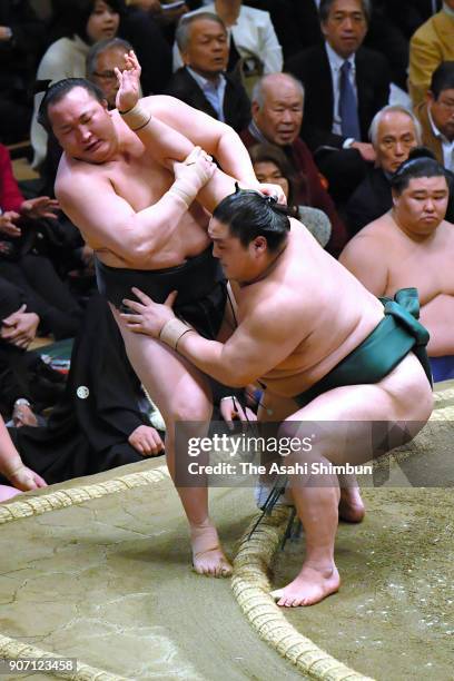Okinoumi pushes Mongolian wrestler Chiyoshoma to win during day six of the Grand Sumo New Year Tournament at Ryogoku Kokugikan on January 19, 2018 in...