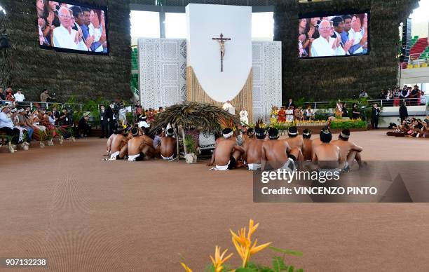 Peru's President Pedro Pablo Kuczynski is seen on the screens as Pope Francis delivers a speech during a meeting with representatives of indigenous...