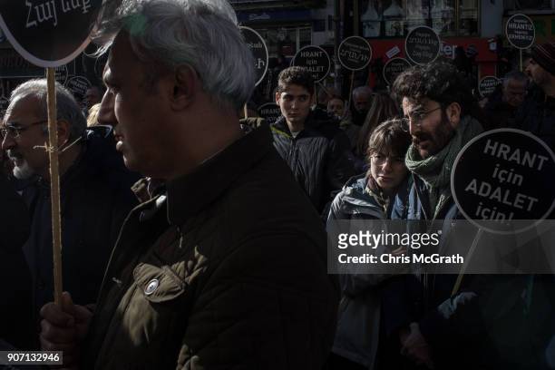 People gather in the street and chant slogans during the 11th anniversary of the assassination of journalist Hrant Dink outside the Agos Newspaper...