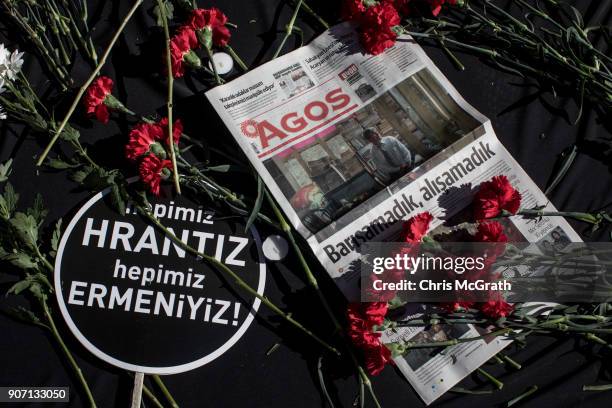 People lay flowers during the 11th anniversary of the assassination of journalist Hrant Dink outside the Agos Newspaper building on January 19, 2018...