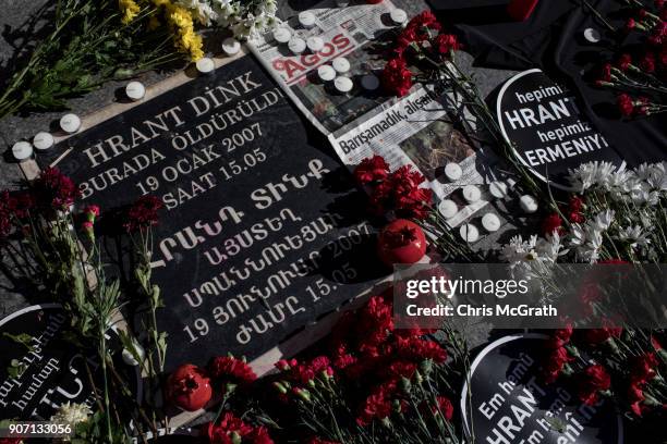 People lay flowers during the 11th anniversary of the assassination of journalist Hrant Dink outside the Agos Newspaper building on January 19, 2018...