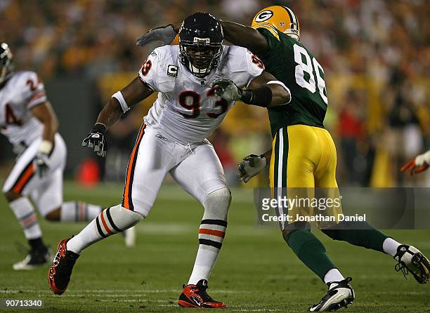 Adewale Ogunleye of the Chicago Bears rushes past Donald Lee of the Green Bay Packers on September 13, 2009 at Lambeau Field in Green Bay, Wisconsin.