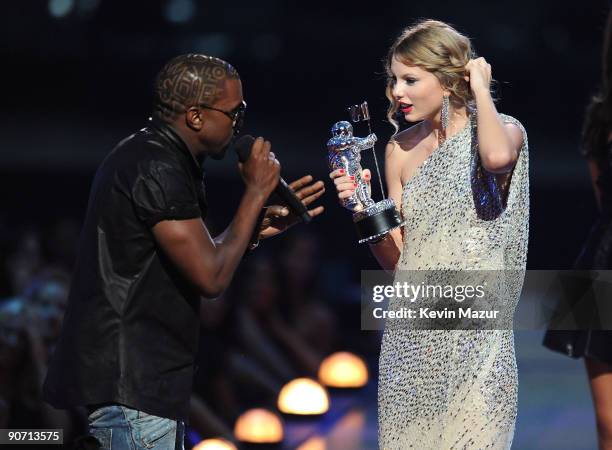 Kanye West takes the microphone from Taylor Swift and speaks onstage during the 2009 MTV Video Music Awards at Radio City Music Hall on September 13,...