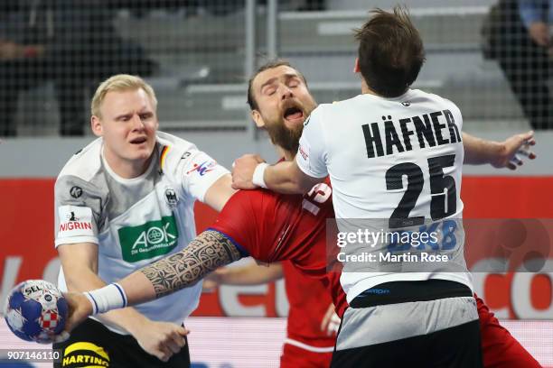 Pavel Horak of Czech Republic is challenged by Kai Haefner and Patrick Wiencek of Germany during the Men's Handball European Championship main round...