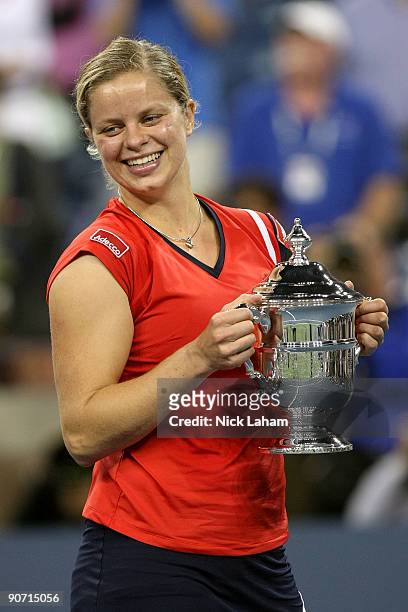 Kim Clijsters of Belgium holds up the championship trophy after defeating Caroline Wozniacki of Denmark in the Women�s Singles final on day fourteen...
