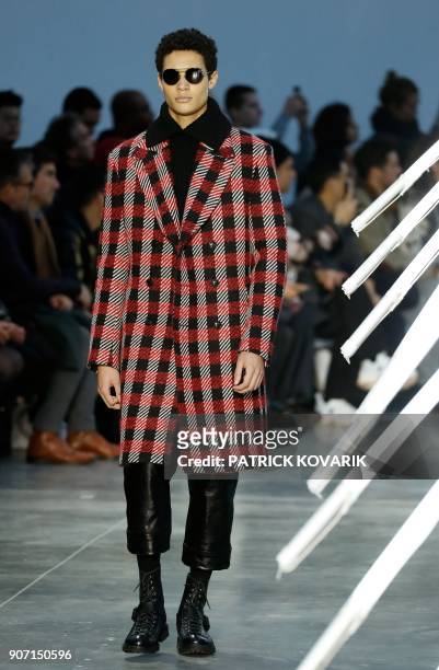 Model presents a creation by Cerrutti during the men's Fashion Week for the Fall/Winter 2018/2019 collection in Paris on January 19, 2018. / AFP...